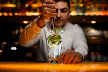 close-up of transparent glass with splashing mojito cocktail