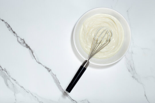 Whipped Cream And Whisk On White Background