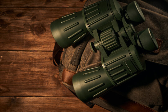 Green Military Binoculars On A Wooden Background