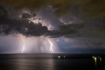 Naklejka na ściany i meble Lightning strikes the Sea of Marmara off the coast of Tekirdag, Turkey, in a cloudy weather