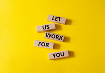Let us work for you symbol. Wooden blocks with words Let us work for you. Beautiful yellow background. Business and Let us work for you concept. Copy space.