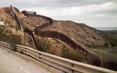 Border wall winding on a hill