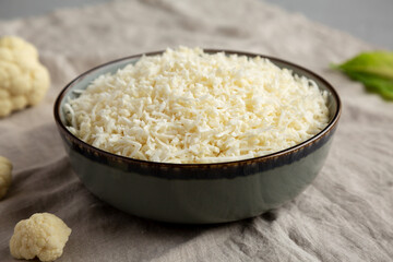 Organic Raw Cauliflower Rice in a Bowl, low angle view. Close-up.