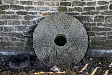 Millstone on the wall of an old farmhouse