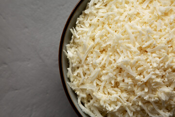 Organic Raw Cauliflower Rice in a Bowl on a gray background, top view. Flat lay, overhead, from above. Copy space.