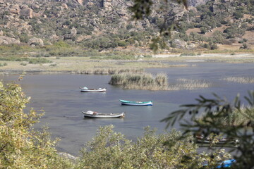 Fishing boats moored along the shore of Lake Bafa in Turkey.	Selective Focus. 