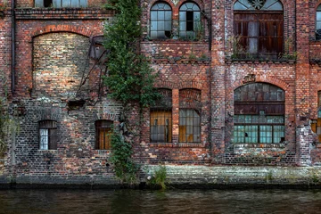 Fototapeten Grunge brick wall with windows © Przemysław Głowik