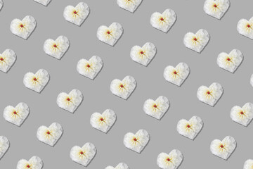 Fototapeta na wymiar Heart shape made of white peony flowers isolated on gray background. Seamless pattern.