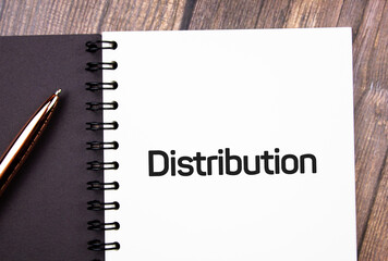 Distribution text on notepad next to pen.Business concept.