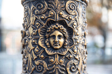 Detail of a street lamp post sculpture in the streets of Paris, France