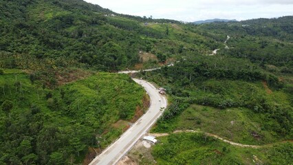 Beautiful view of a green landscape with a road on a hill