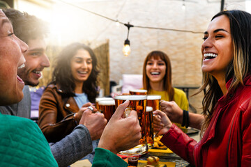 Happy group  friends cheering glasses beer in a bar restaurant-Smiling young people enjoying happy...