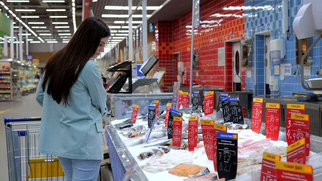 Girl at the fish counter, sea fish, seafood discount