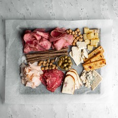 Cheese and meat platter on a grey marble table top