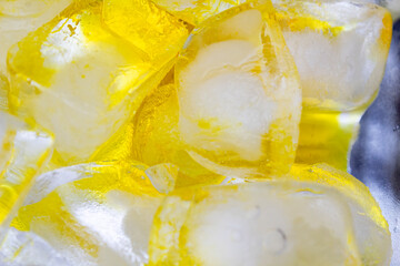 Ice cubes on yellow background 