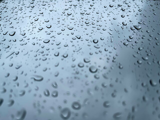 Rainwater drops running down the window glass