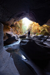 Adventurous woman standing inside a cave. Adventure Travel. Little Huson Caves Park, Vancouver...