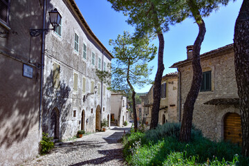 A narrow street between the old stone houses of Civitavecchia di Arpino, a medieval village in the Lazio region, Italy.