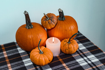 halloween pumpkins and candle on blanket