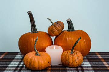 halloween pumpkins and candle on blanket
