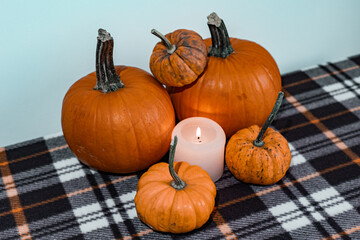 halloween pumpkins and candle on blanket