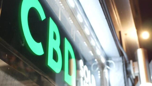 Neon sign in smoke shop, legalized cbd oil or medical cannabis in store, California USA. Legal sale of cannabidiol, weed, hemp, marijuana, ganja or hashish in dispensary. Cannabinoids in drugstore.