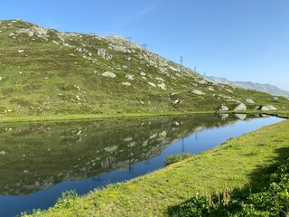 Summer atmosphere on the Lago di Rodont lake (Lake Rodont) in the Swiss alpine area of the mountain St. Gotthard Pass (Gotthardpass), Airolo - Canton of Ticino (Tessin), Switzerland (Schweiz)