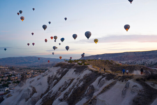 Stunning sunset viewed from bird's eye perspective showing numerous colourful hot air ballon flying over Cappadocia. Turkish touristic attractions. High quality photo