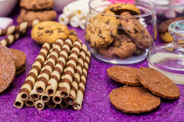 Chocolate and biscuits background. Chocolate and biscuits background. Many pieces of chocolate, candies, cookies, biscuits, cakes, donuts, and other sweets. Milk chocolate and dark chocolate, waffle c