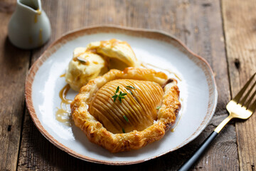 Hasselback pear in puff pastry with vanilla ice cream