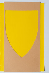 shield or banner frame on yellow and blank paper