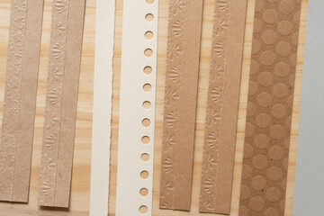 paper stripes (vertical orientation) on wood