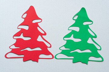 two christmas tree glyphs or dingbat cutouts on blank paper