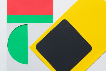black box on yellow with gray paper stencil and semi-circle cutout