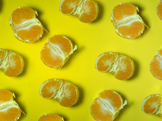 Background from slices of tangerines. Citrus abundance. Yellow. Fruit pulp concept.