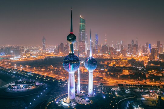Illuminated towers with cityscape view while Kuwait City celebrating the national day
