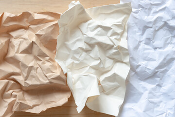 Obraz premium three pieces of crumpled paper on wood