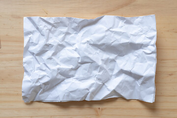 crumpled paper on wood