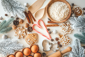 Fototapeta na wymiar Bakery background with ingredients for cooking Christmas baking. Flour, eggs, cinnamon and gingerbread on the table top view
