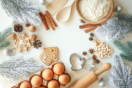 Bakery background with ingredients for cooking Christmas baking. Flour, eggs, cinnamon and gingerbread on the table top view