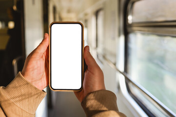 Phone in hands with an isolated screen on the background of the train cabin