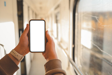 Phone in hands with an isolated screen on the background of the train cabin