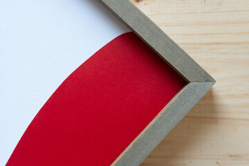 wood frame (focus point is on the actual frame and not the white panel and red paper, which are out of focus)