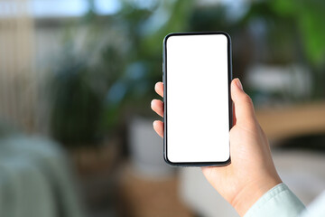 Closeup view of woman with smartphone indoors. Space for text