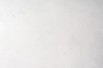 Rough textured concrete surface painted in white. Grunge background