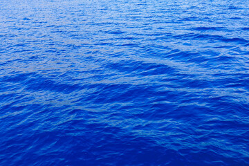 Very nice sea water background or backdrop with selective focus. Small waves of natural water surface texture.