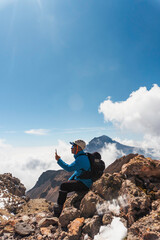 Man using smartphone application navigation in mountains travel.