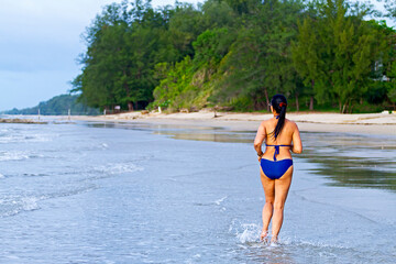Woman with swimsuit happy morning at beach