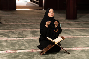 Humble Muslim Woman is Praying in the Mosque