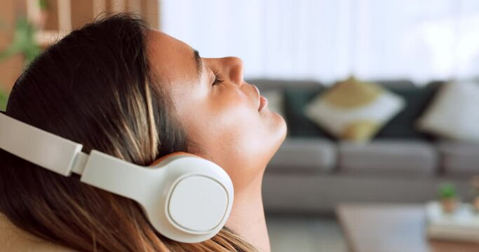Woman face, relax and music headphones, living room sofa and wellness, peace and freedom of easy lifestyle. Mindfulness, meditation and young girl listening to radio, audio and dream podcast in home
